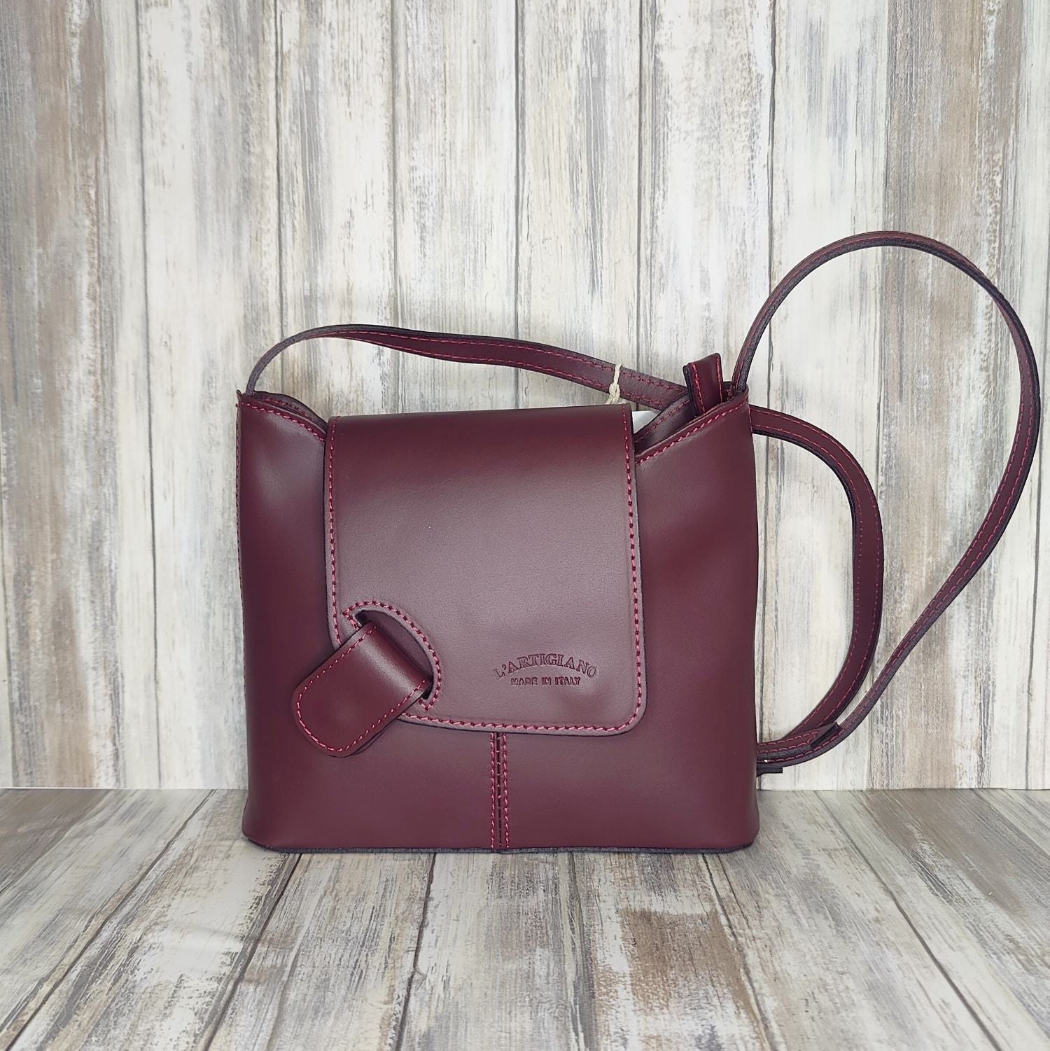 Crafted with Italian leather, this cross body bag features a magnetic dot and zip closure and an adjustable strap for a stylish look.       Back Zip Pocket   Internal Slip Pocket   Silver Hardware   H20cm x W24cm x D6cm