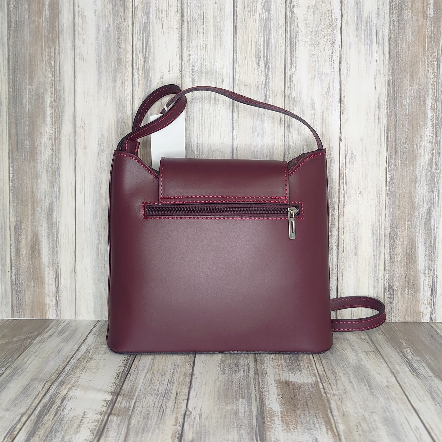 Crafted with Italian leather, this cross body bag features a magnetic dot and zip closure and an adjustable strap for a stylish look.       Back Zip Pocket   Internal Slip Pocket   Silver Hardware   H20cm x W24cm x D6cm