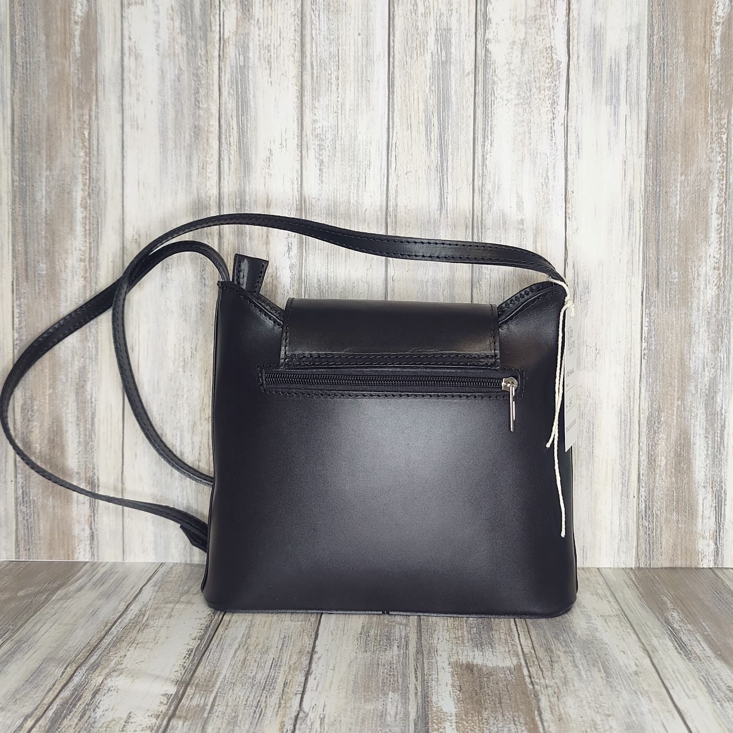 Crafted with Italian leather, this cross body bag features a magnetic dot and zip closure and an adjustable strap for a stylish look.       Back Zip Pocket   Internal Slip Pocket   Silver Hardware   H20cm x W24cm x D6cm