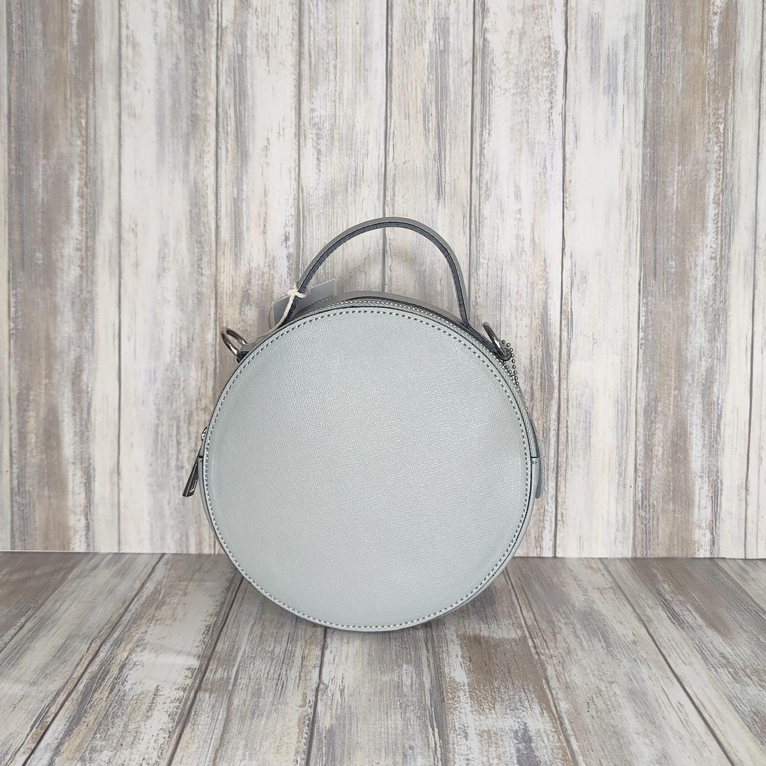 This stylish Italian leather round grab bag is an essential addition to any wardrobe. With a two-zip closure and unique shape, it is a versatile accessory for any occasion. The bag also features a convenient grab handle as well as a detachable long crossbody strap.   Maximum handle drop 60cm   Silver hardware   h:19cm x w19cm x d8cm 