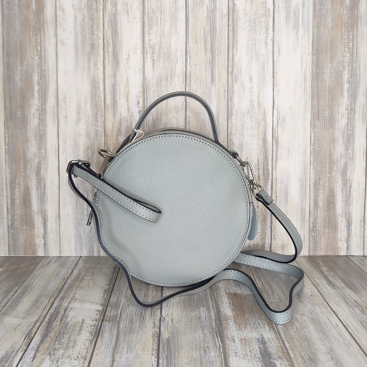 This stylish Italian leather round grab bag is an essential addition to any wardrobe. With a two-zip closure and unique shape, it is a versatile accessory for any occasion. The bag also features a convenient grab handle as well as a detachable long crossbody strap.   Maximum handle drop 60cm   Silver hardware   h:19cm x w19cm x d8cm 