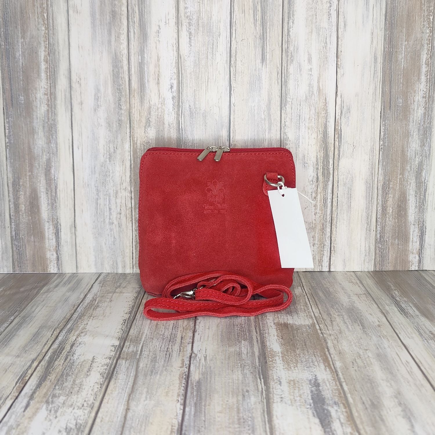 This stylish suede messenger bag is the ideal companion for your day-to-night looks, featuring detachable straps for easy transitions. Fully lined for convenience, a central zip compartment and an external zip pocket provide ample storage for all your needs.   Silver hardware   Detachable Strap       w:16cm x h:17cm x d: 8cm 