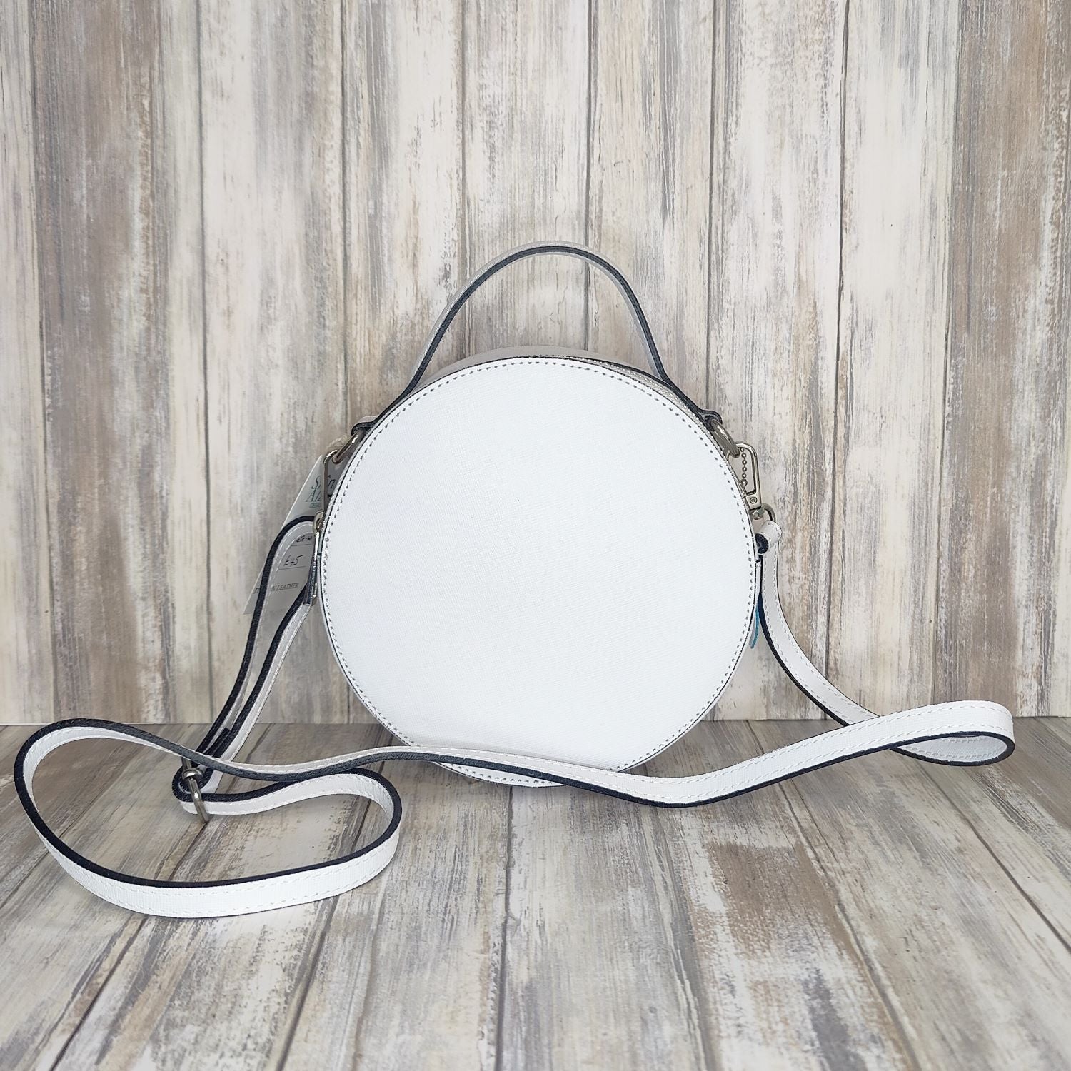 This stylish Italian leather round grab bag is an essential addition to any wardrobe. With a two-zip closure and unique shape, it is a versatile accessory for any occasion. The bag also features a convenient grab handle as well as a detachable long crossbody strap.   Maximum handle drop 60cm   Silver hardware   h:19cm x w19cm x d8cm 