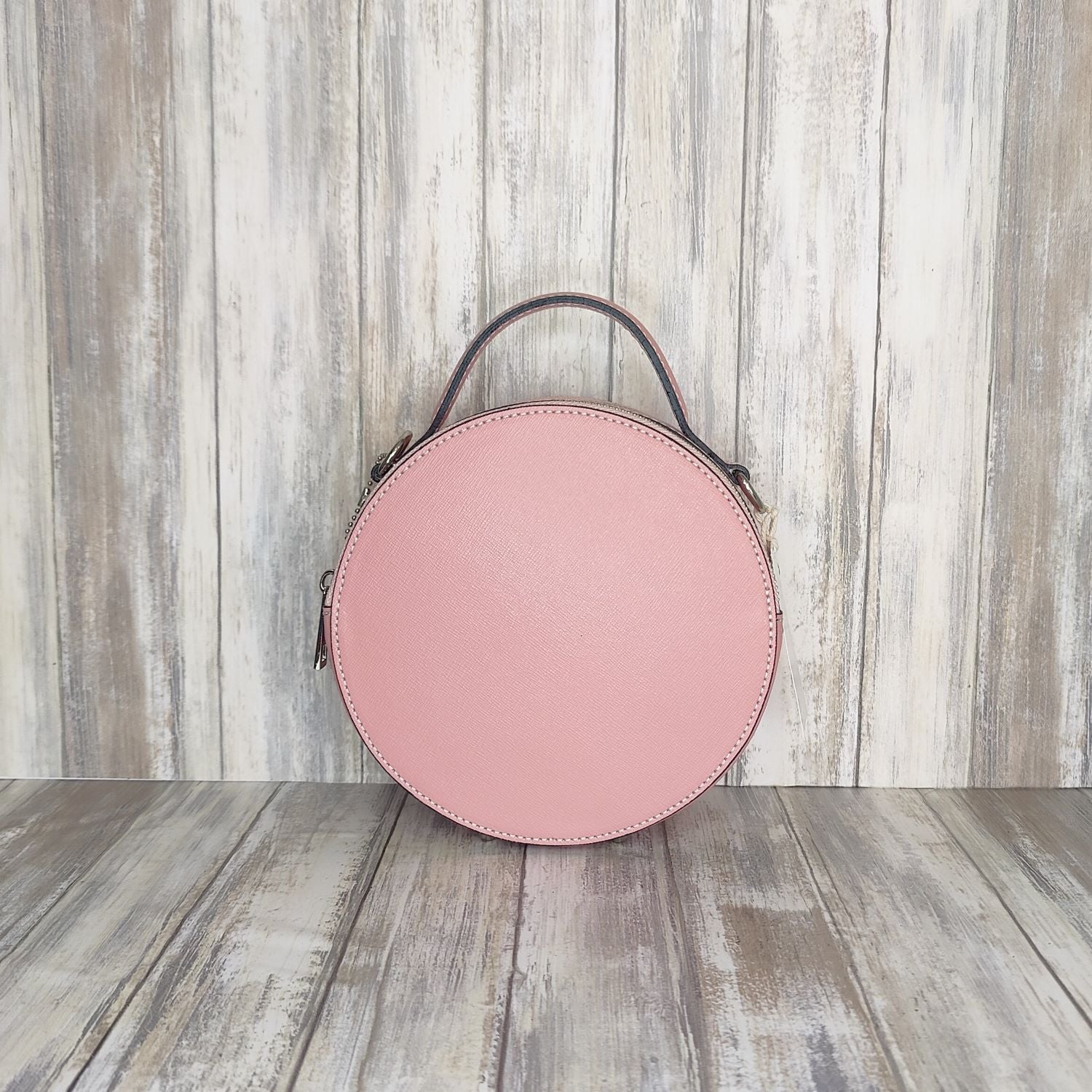 This stylish Italian leather round grab bag is an essential addition to any wardrobe. With a two-zip closure and unique shape, it is a versatile accessory for any occasion. The bag also features a convenient grab handle as well as a detachable long crossbody strap.   Maximum handle drop 60cm   Silver hardware   h:19cm x w19cm x d8cm 