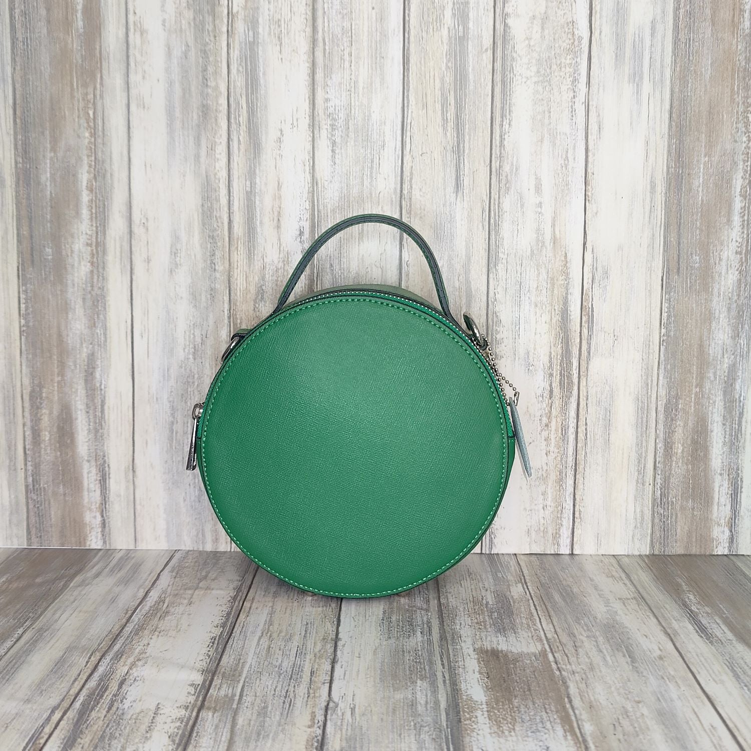 This stylish Italian leather round grab bag is an essential addition to any wardrobe. With a two-zip closure and unique shape, it is a versatile accessory for any occasion. The bag also features a convenient grab handle as well as a detachable long crossbody strap.   Maximum handle drop 60cm   Silver hardware   h:19cm x w19cm x d8cm 