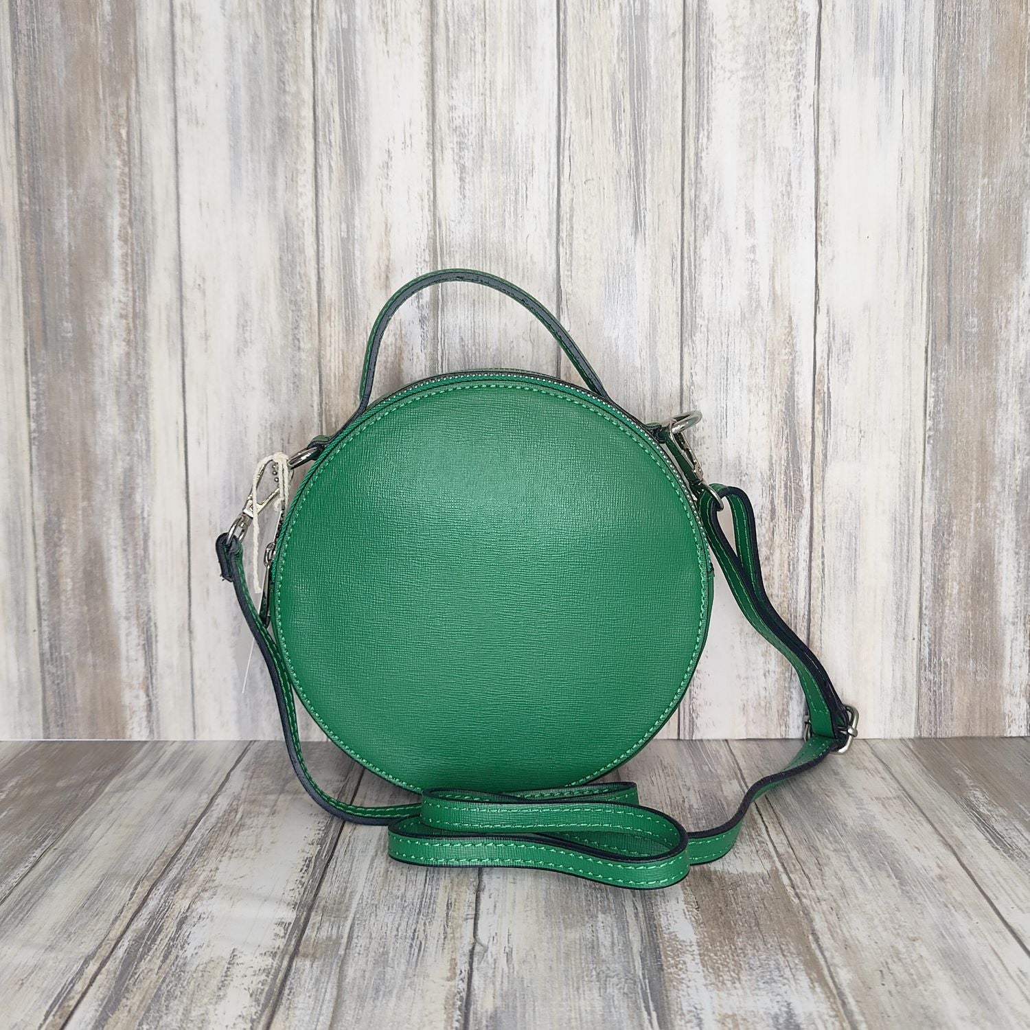 This stylish Italian leather round grab bag is an essential addition to any wardrobe. With a two-zip closure and unique shape, it is a versatile accessory for any occasion. The bag also features a convenient grab handle as well as a detachable long crossbody strap.   Maximum handle drop 60cm   Silver hardware   h:19cm x w19cm x d8cm 