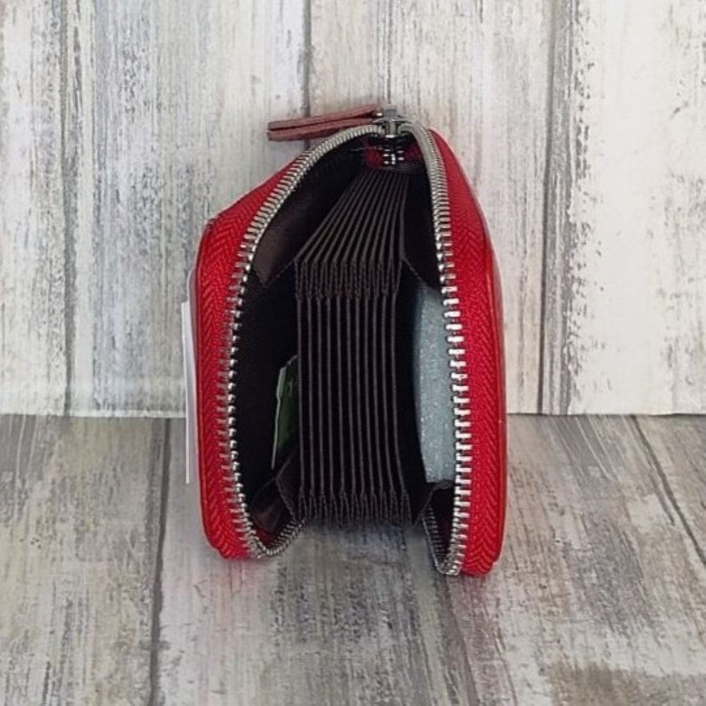 This classic leather card holder features 12 card slots for easy organization. It also includes a single zip and enough space to store a few notes or receipts. Made from premium pebbled leather, it is lightweight yet durable, offering a perfect balance of style and convenience.