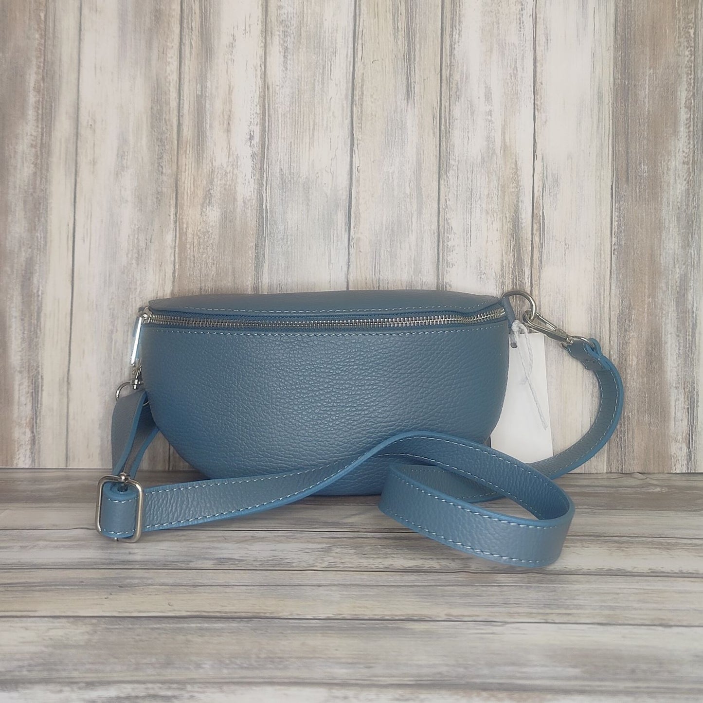 Made with soft  Italian leather, our Sling Bag/Bum Bag is the perfect combination of chic and practical. Enjoy easy access to your essentials when you're on the go, and elevate your look with confidence!  Top Zip Closure  Internal pocket  Silver Hardware  h:12cm x w:26cm x d:9cm 