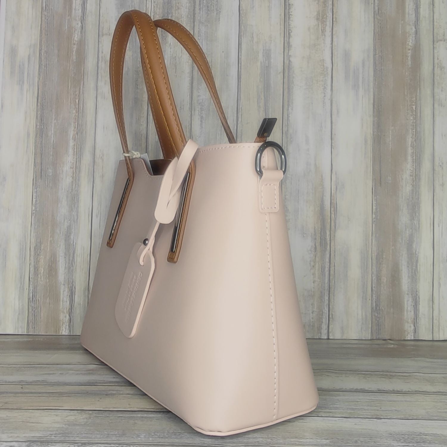 Elevate your style with this stunning Italian leather double compartment handbag.  Its soft yet structured design looks beautiful and feels equally beautiful to wear. This is a classic design that will match with any outfit and is the perfect size for all your essential items. Get ready to make a statement with this fashionable and functional addition to your wardrobe.  We love this bag!