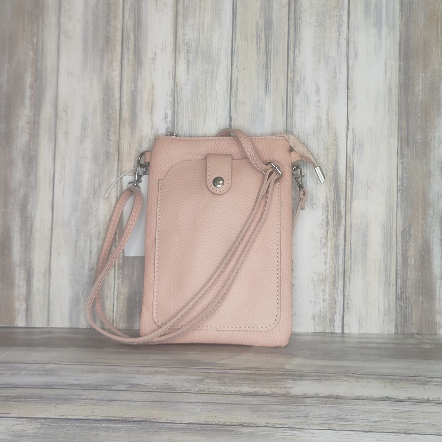 This Italian leather pebbled leather mini bag has it all. It's designed with a phone holder, slick zip closure, and a long cross body detachable and adjustable strap, making it perfect for any occasion. You'll have peace of mind knowing your essentials are safe and secure.  Silver Hardware  Measurement: h21cm x w14cm x d2cm