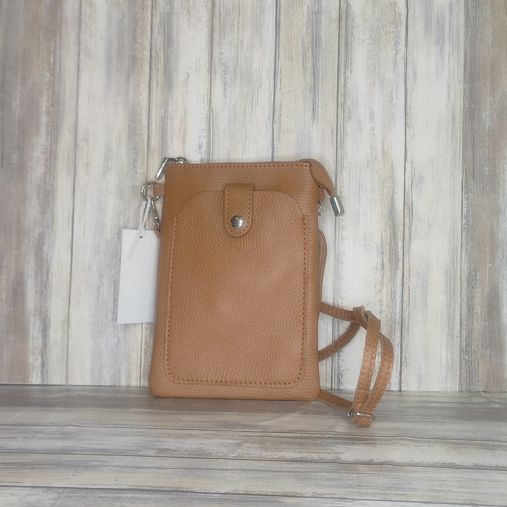 This Italian leather pebbled leather mini bag has it all. It's designed with a phone holder, slick zip closure, and a long cross body detachable and adjustable strap, making it perfect for any occasion. You'll have peace of mind knowing your essentials are safe and secure.  Silver Hardware  Measurement: h21cm x w14cm x d2cm