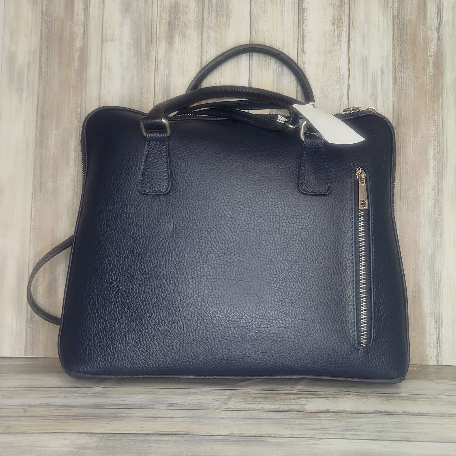 Make an impact with this sleek, unisex Italian leather laptop bag. With an adjustable shoulder strap it will fit perfectly. And you'll love the convenience of the interior laptop pocket, inner zip pocket, and exterior zip pocket. Stand out in style!  w:34cm x h:29cm x d:7cm