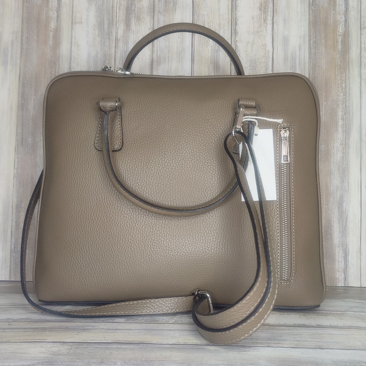 Make an impact with this sleek, unisex Italian leather laptop bag. With an adjustable shoulder strap it will fit perfectly. And you'll love the convenience of the interior laptop pocket, inner zip pocket, and exterior zip pocket. Stand out in style!  w:34cm x h:29cm x d:7cm