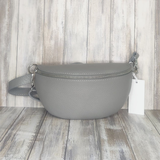 Made with soft  Italian leather, our Sling Bag/Bum Bag is the perfect combination of chic and practical. Enjoy easy access to your essentials when you're on the go, and elevate your look with confidence!  Top Zip Closure  Internal pocket  Silver Hardware  L:12cm x W:26cm x D:9cm