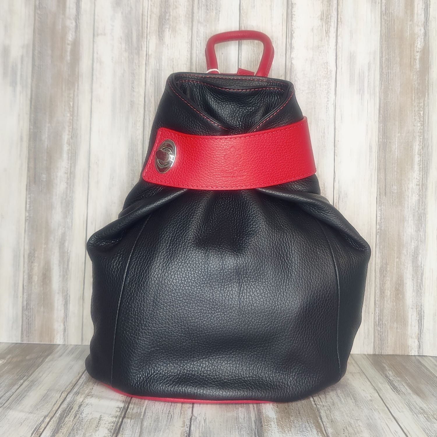 Discover the perfect blend of style and convenience with this Italian leather postman's lock backpack! Its sumptuous, pebbled leather offers timeless sophistication and makes a bold statement wherever you go. Keep your belongings safe and secure with both the postman's lock and zip closure. And with its spacious design, you'll have plenty of room to store your everyday essentials.   Adjustable straps   Grab handle   Fully lined   Back zip pocket   Internal zip pocket   H:35cm x W:33cm x D:13cm 