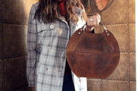 Indulge in luxury with our Zaha Leather Handbag/Tote Bag. Crafted with top grain leather, this statement piece boasts a unique design that is sure to turn heads. Its spacious main compartment includes an organizer panel for your essentials, while the microfibre lining and adjustable shoulder strap provide ultimate comfort. We absolutely love this one!