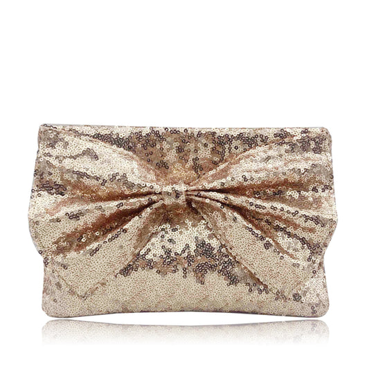 Shine and sparkle with the Ginny Large Bow Glitter Clutch Bag. This stunning and sequinned evening bag features a large bow design, adding an elegant touch to any outfit. With a detachable chain strap and ample room for essentials, this clutch offers both style and practicality. Perfect for a night out, wedding or special occasion.