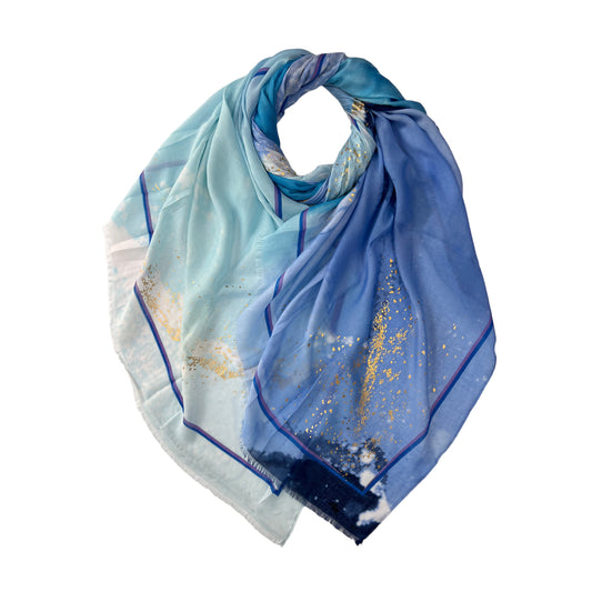 Wrap yourself in luxury with our Ocean Wave Printed Scarf. Featuring a stunning ocean wave print and accented with shimmering silver and gold patches, this scarf is both elegant and eye-catching.