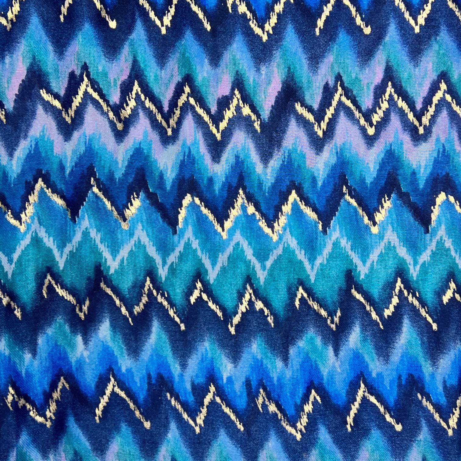 This beautiful scarf is crafted from a cotton blend fabric, featuring a stunning wave pattern in beautiful blue. The fringed ends and vibrant colour add a stylish accent to any outfit.