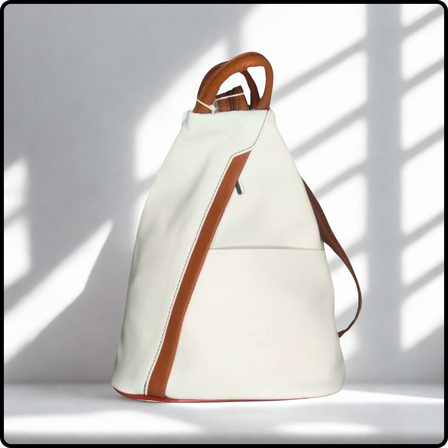 White backpack with brown accents on a light gray background