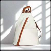 White backpack with brown accents on a light gray background