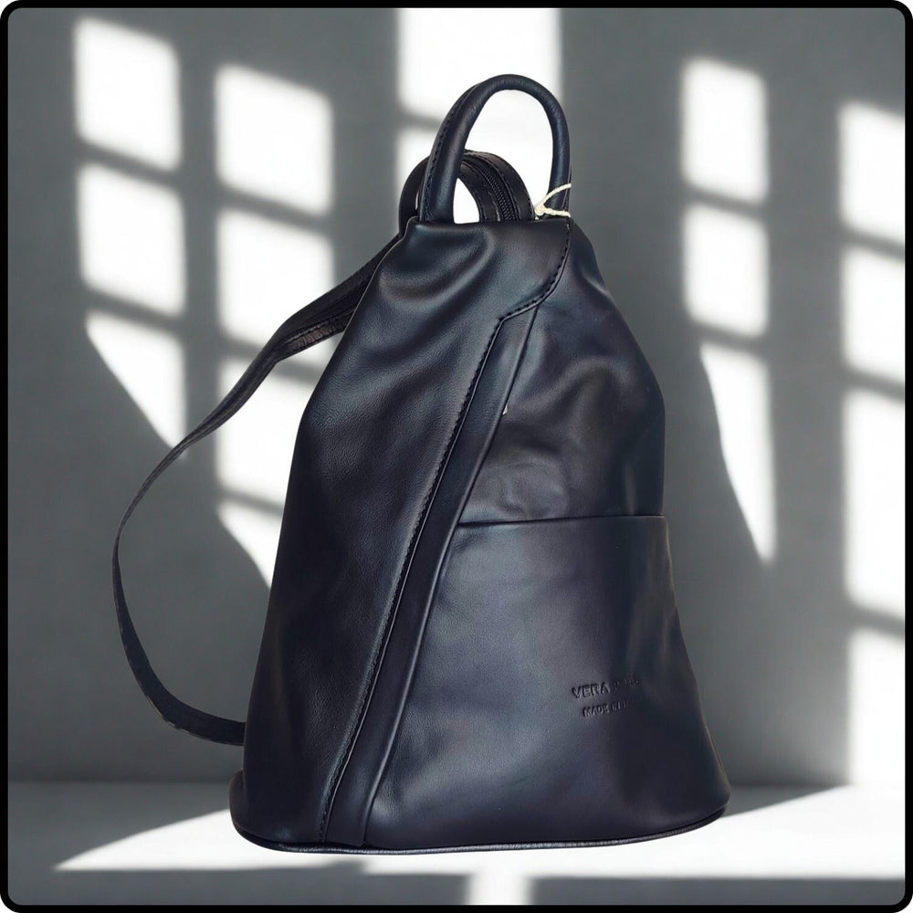 Black leather backpack on a light background