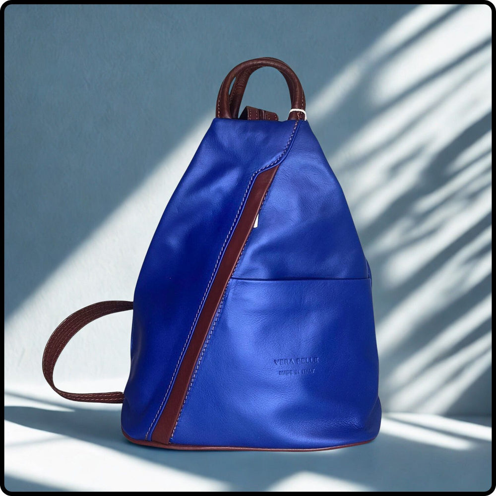 Blue backpack with brown straps on a light blue background