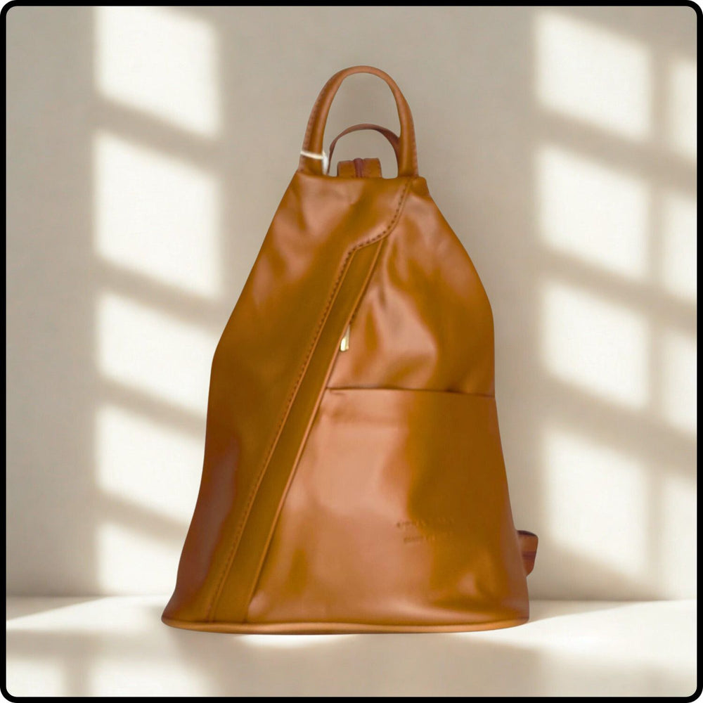 Brown leather backpack on a light background