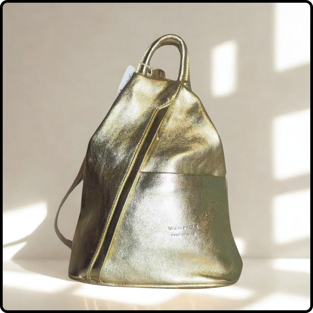 Gold metallic backpack on a light background