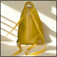 Yellow leather backpack on a light background