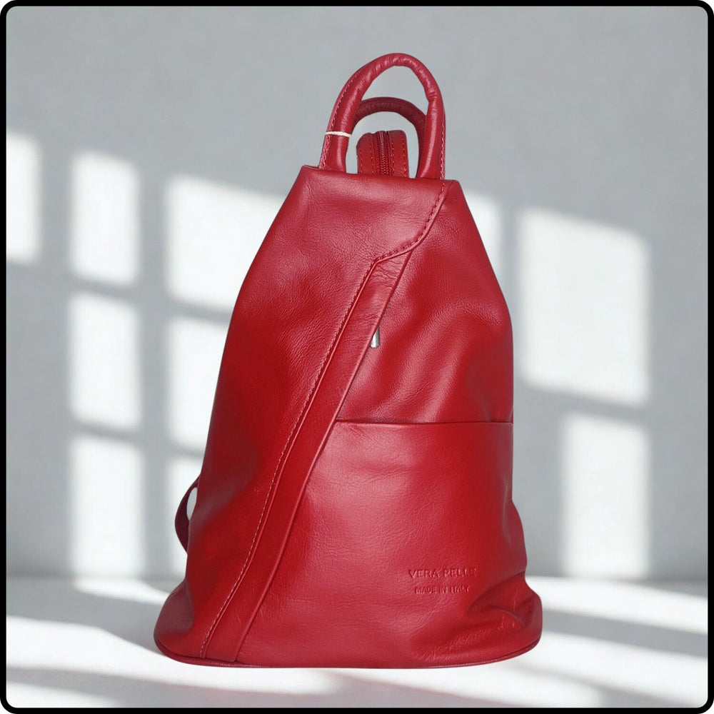Red leather backpack on a light gray background