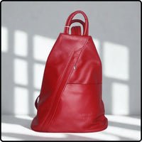 Red leather backpack on a light gray background