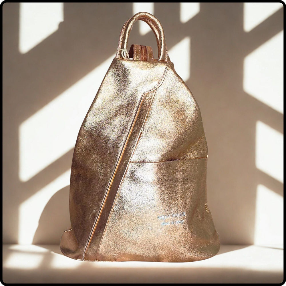 Gold metallic backpack on a light background