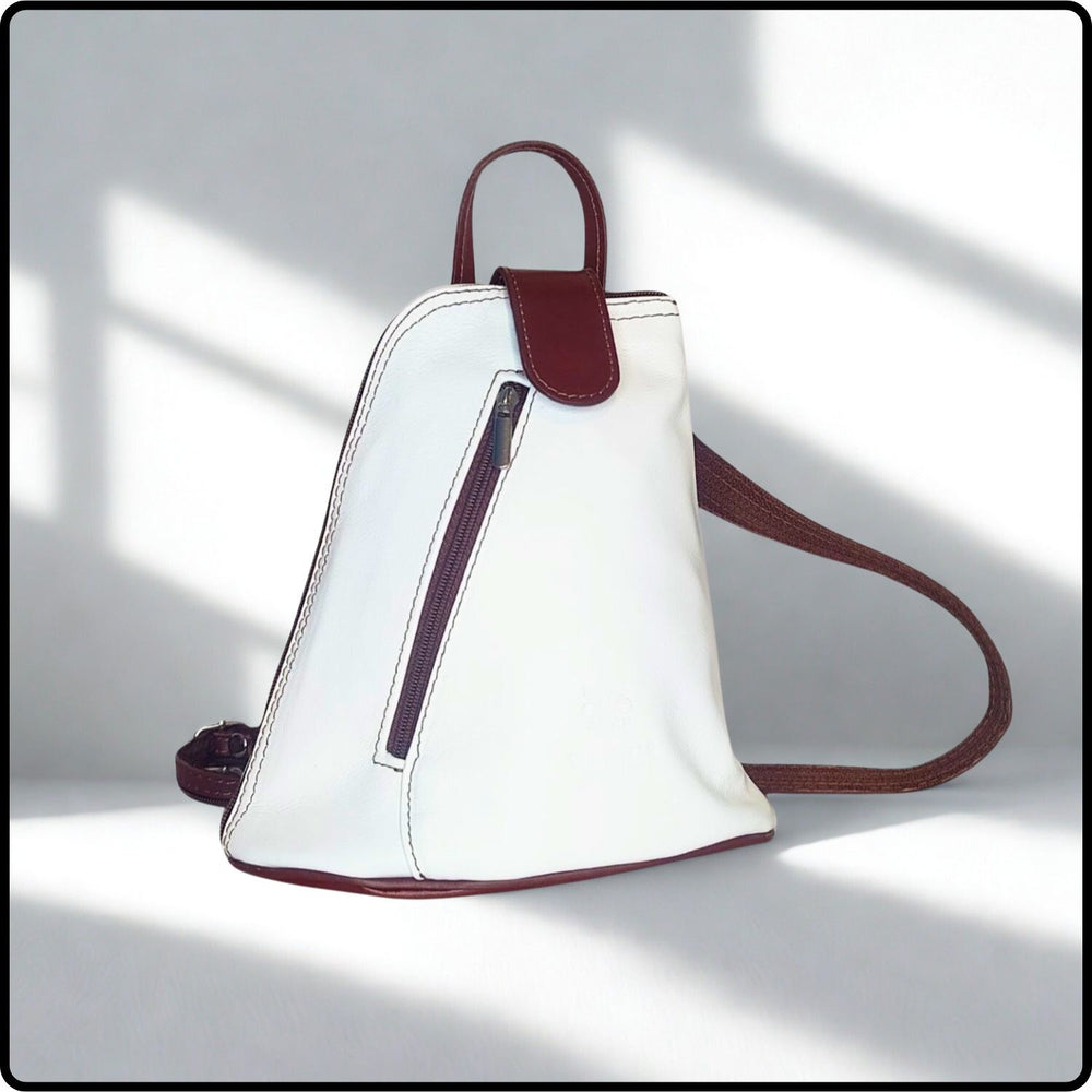 White handbag with brown accents on a light gray background