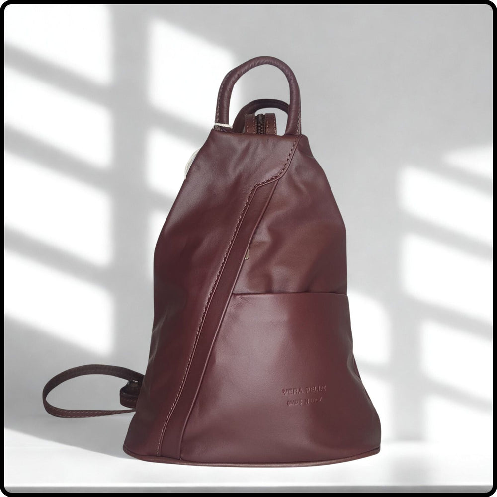 Brown leather backpack on a light background