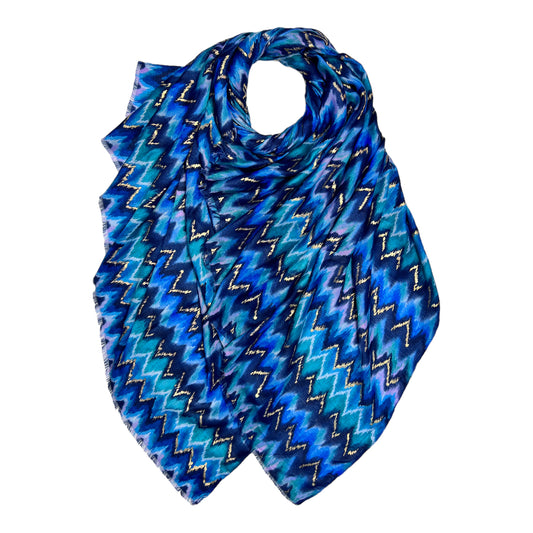 This beautiful scarf is crafted from a cotton blend fabric, featuring a stunning wave pattern in beautiful blue. The fringed ends and vibrant colour add a stylish accent to any outfit.