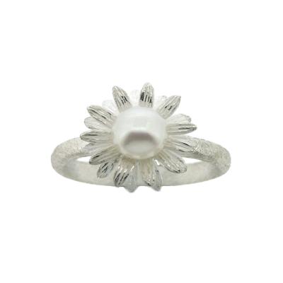 A pretty Pearl set sunflower ring set on a brushed sterling silver band.  The width of the decorative design of the ring is 13mm, height 13mm and the depth is 8mm. The width of the band is 3mm. All measurements are approximate and measured at widest/longest point.   Delivered gift boxed.